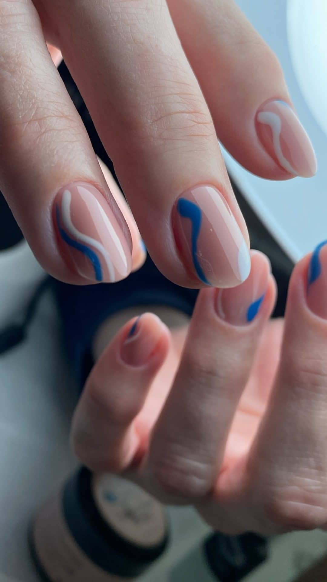 Short nails with abstract nail art in rose and blue