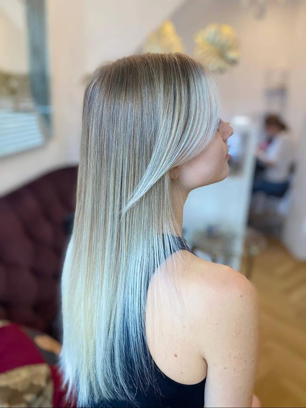 Sleek blonde fading to silver, from the side