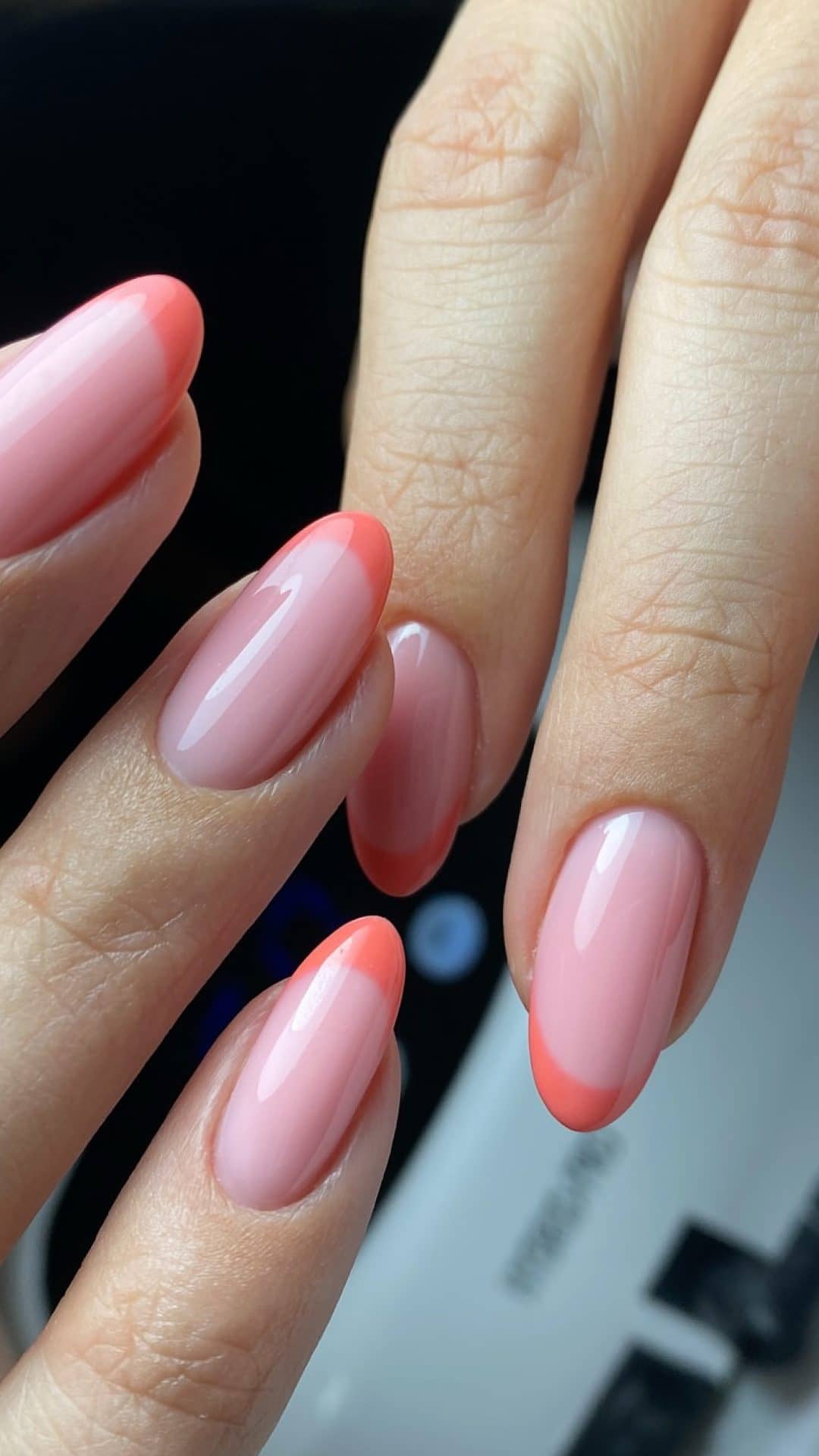 Almond nails with a coral French tip