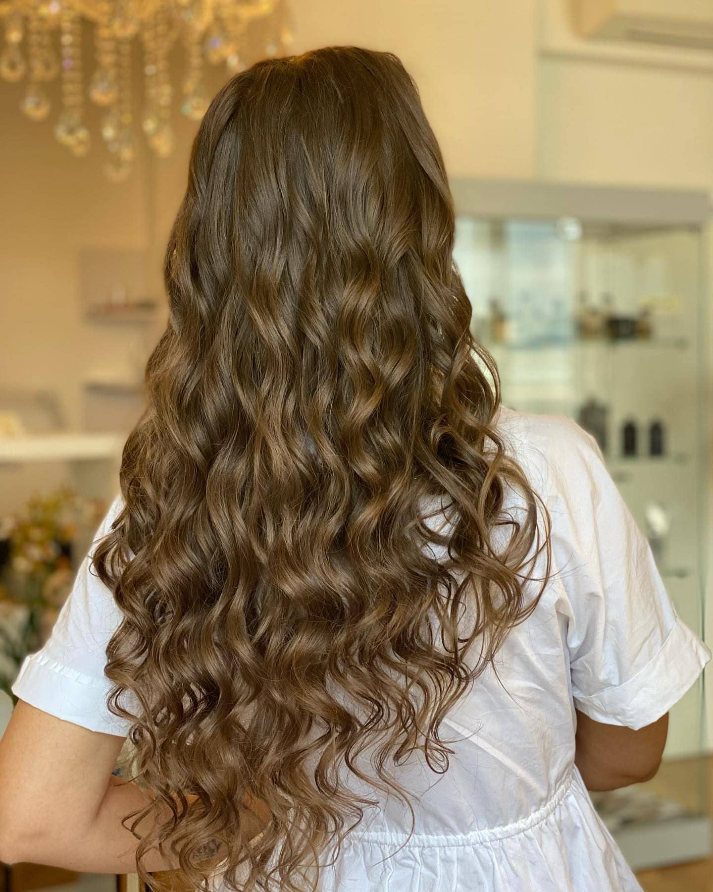Long, healthy brown curls, from behind